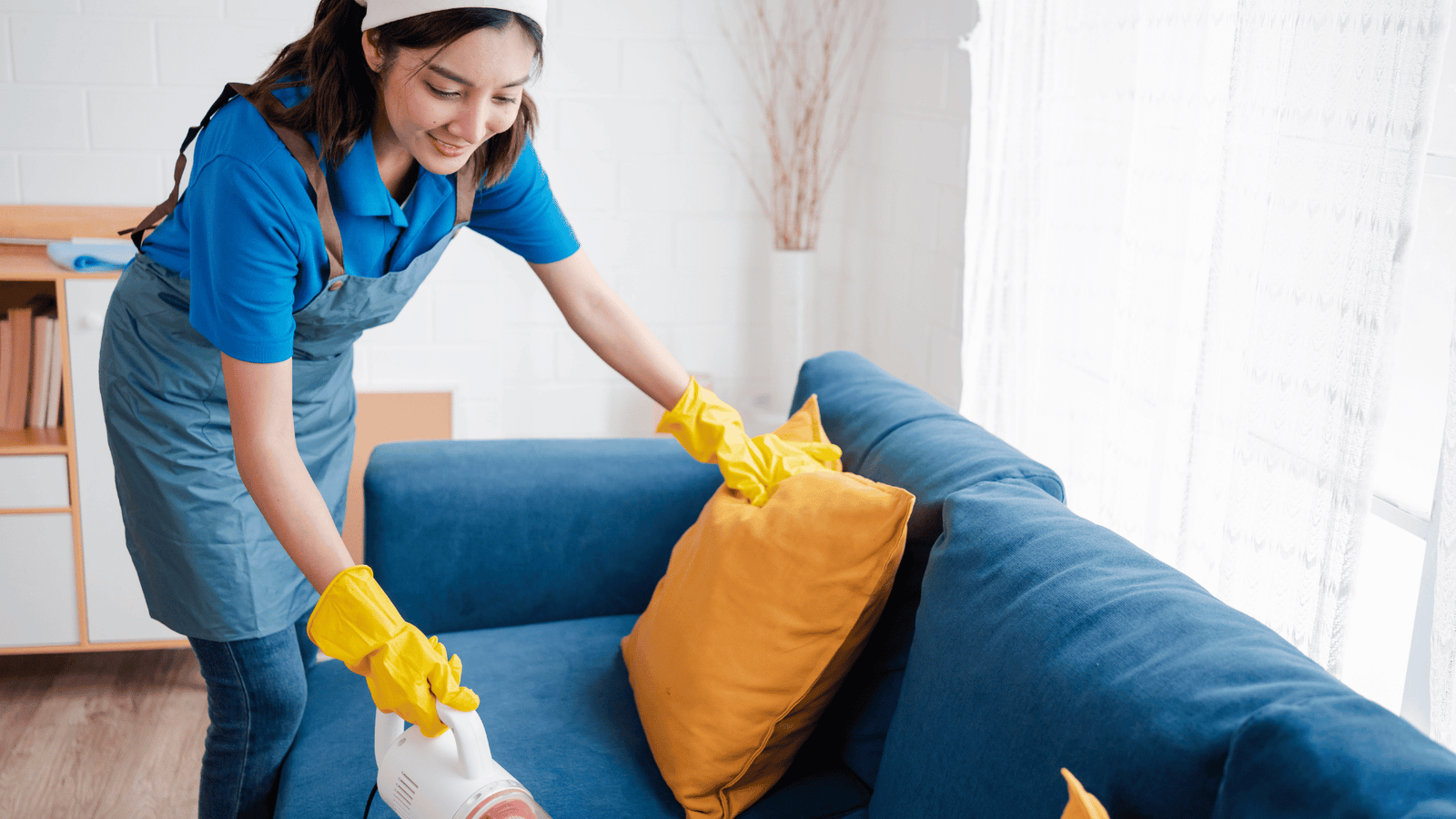 Cleaner vacuuming couch during move-out cleaning service by 302CleanIt in New Castle County DE